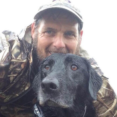 Homem com cão de resgate